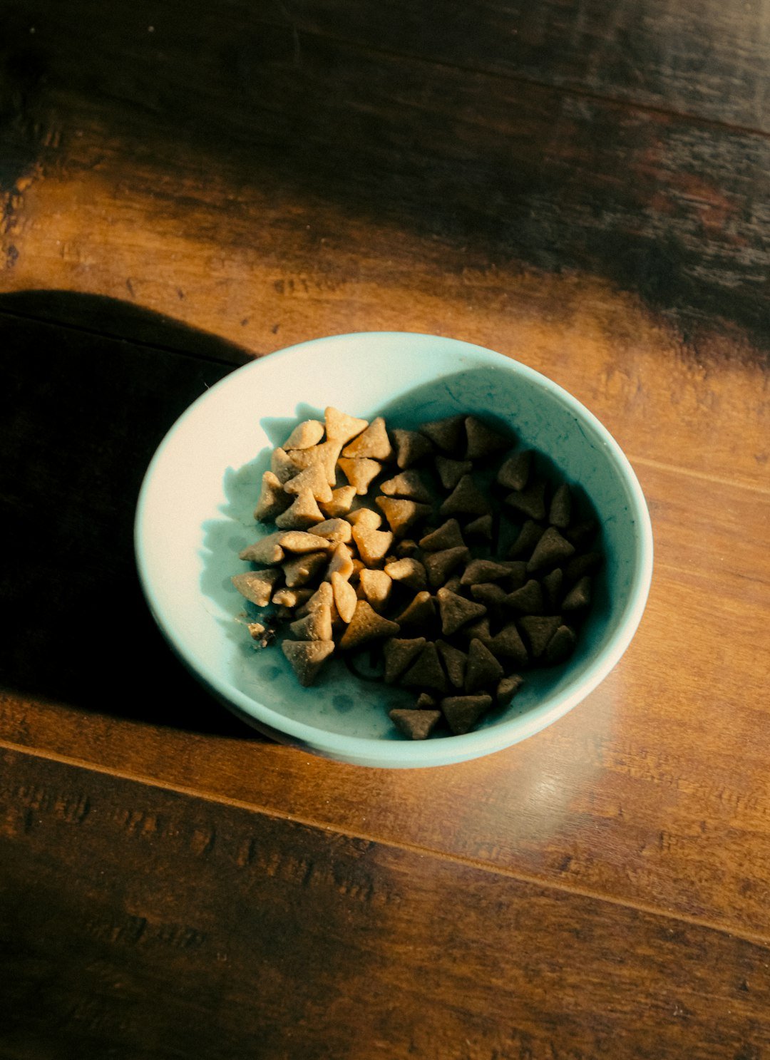 A small bowl filled with various whole nuts like almonds, walnuts, and cashews.